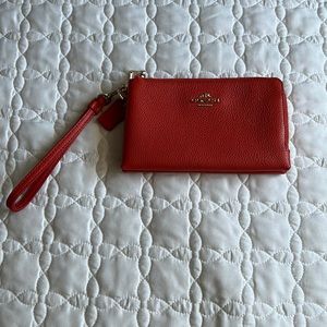 Coach salmon colored double zipper wristlet